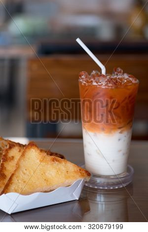 Garlic Bread In White Paper Tray Served With Thai Milk Tea In The Breakfast