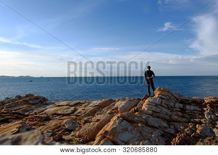 One Man Put His Hand Behind Him. And Make A Fight Symbol On The Rock By The Sea At Khao Laem Ya, Ray