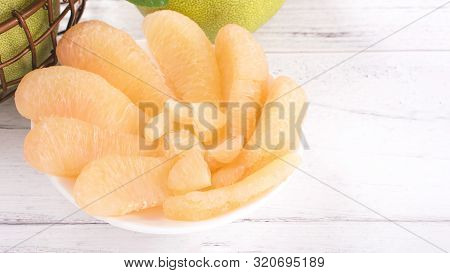 Fresh Peeled Pomelo, Grapefruit, Shaddock On Bright Wooden Table Background. Seasonal Fruit For Mid-