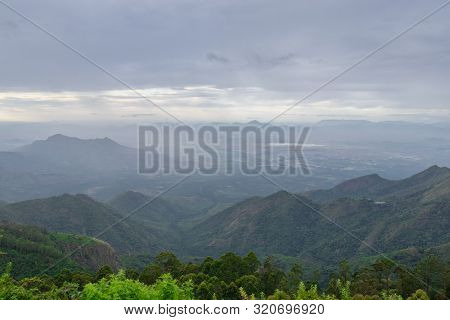 Mountain Range In Mist With Forest Image Taken At Kodaikanal Tamilnadu India From Top Of The Hill. I