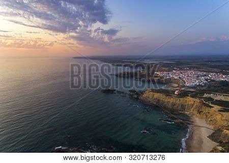 Aerial View Of The Zambujeira Do Mar Village And Beach At Sunset, In Alentejo, Portugal;