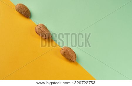 Minimal Modern Composition With No Shelled Almonds On Green Yellow Background. Flat Lay With Food An