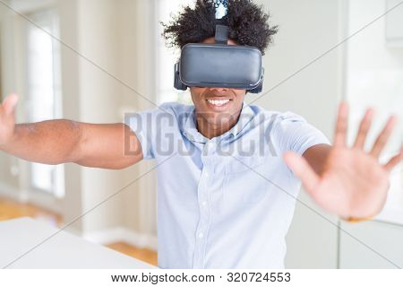 African amaerican man having fun playing with virtual reality glasses