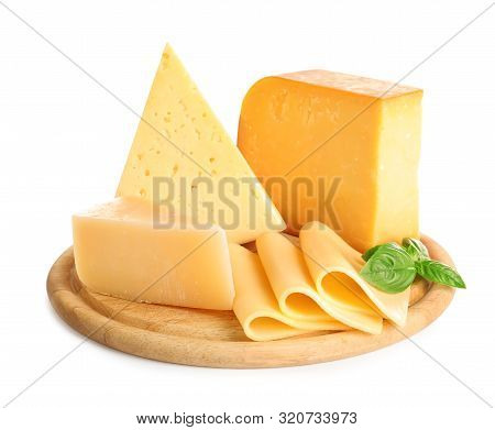 Wooden Board With Different Kinds Of Cheese And Basil On White Background