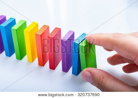 Colorful Domino Blocks In Hand On A White Background