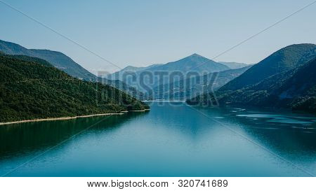 Zhinvali Reservoir Lake Landscape With Mountains . The Main Caucasus Ridge.