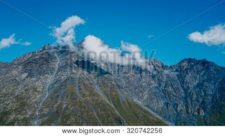 View Of Kazbegi, Georgia. Beautiful Natural Mountain Background. Summer