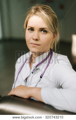 Portrait Of Woman Doctor Resting After Surgery. Girl Doctor Resting During A Break After Admission T