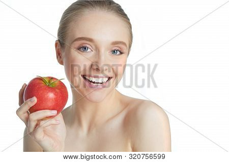 Portrait Of Happy Smiling Young Beautiful Woman Eating Red Apple, Over White Background