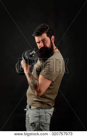 Athletic Young Male Fitness Model Holds Dumbbell. Fit Young Man In Sportswear Holds Dumbbell During 