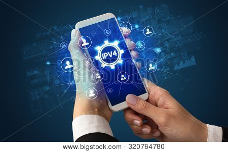 Female hand holding smartphone with IPV4 abbreviation, modern technology concept