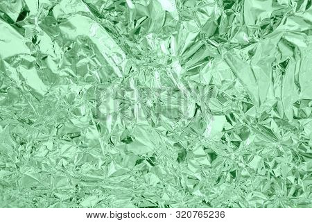 Abstract Trendy Mint Colored Crumpled Foil Texture Background. Color Trend Concept.