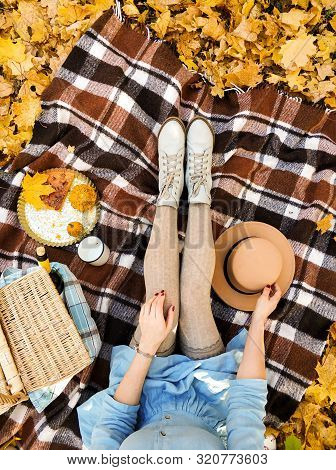 Girl In A Dress In A Park Drinking Tea The Autumn Season. Picnic. Feet Shoes Walking In Nature. View