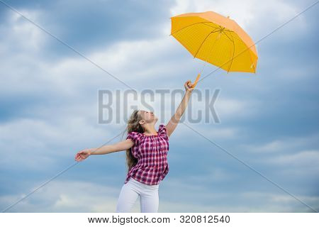 Child Fly In Cloudy Sky. Rain Protection. Happy Small Girl With Umbrella. Positive Mood At Any Weath