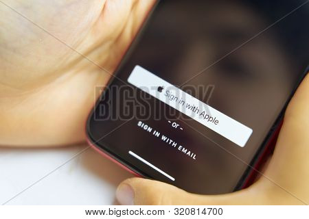 Bishkek, Kyrgyzstan - June 6, 2019: Sign In With Apple Button For Your Privacy. Man Holds A Smartpho