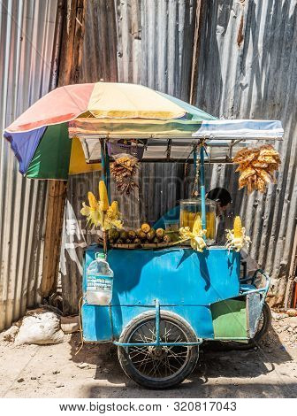 Balabag, Boracay Island, Philippines - March 4, 2019: Blue Fast Food Motorcycle Cart With Rainbow Um