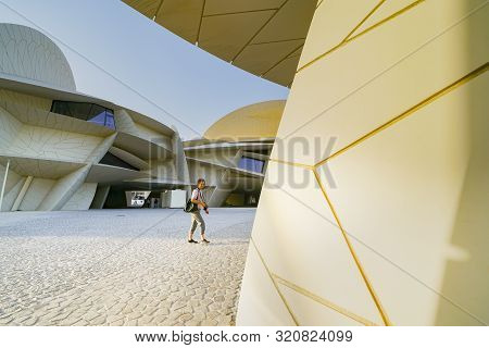 Doha Qatar - July 10 2019; Tourist Crosses Courtyard In National Museum Of Qatar Unusual But Strikin