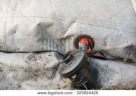 Inflate A Rubber Boat. Repair The Pump In The Boat. Man Thinks Up A Boat. Preparation For Fishing.