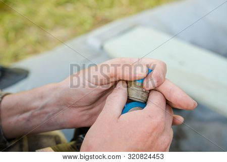 Inflate A Rubber Boat. Repair The Pump In The Boat. Man Thinks Up A Boat. Preparation For Fishing.