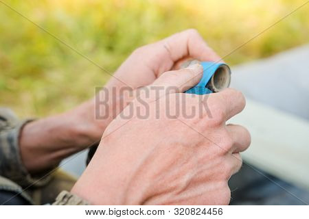 Inflate A Rubber Boat. Repair The Pump In The Boat. Man Thinks Up A Boat. Preparation For Fishing.