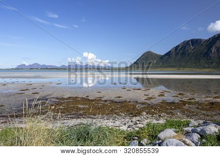 Reflection Of Clouds And Mountains In The Water At Grunnfor On Austvagoy In Northern Lofoten, Norway