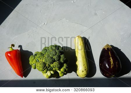 Ugly Vegetables Laid Out In Row On Grey Concrete Background