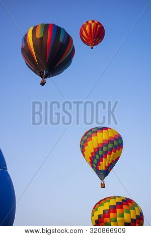 Festival Goers Watch Hot Air Balloons Take To Flight Early Saturday Morning On A Cloudless Sky At Th