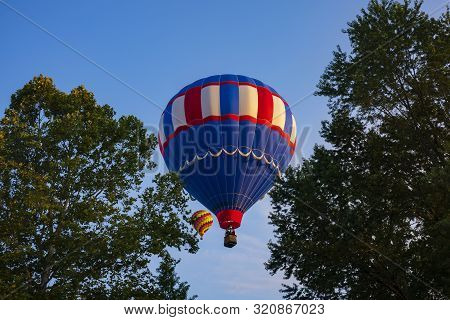 Festival Goers Watch Hot Air Balloons Take To Flight Early Saturday Morning On A Cloudless Sky At Th