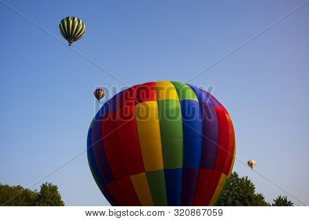 Festival Goers Watch Hot Air Balloons Take To Flight Early Saturday Morning On A Cloudless Sky At Th