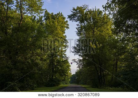 Festival Goers Watch Hot Air Balloons Take To Flight Early Saturday Morning On A Cloudless Sky At Th