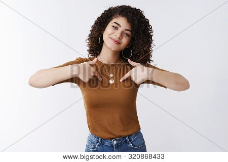 Me Who You Need. Self-assured Attractive Cheerful Curly-haired Glad Girl Bragging Pointing Herself C