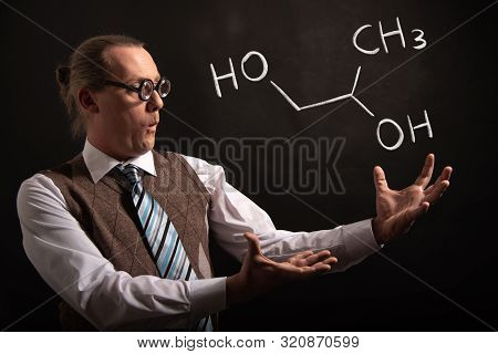 Professor Presenting Handdrawn Chemical Formula Of Propylene Glycol -1,2