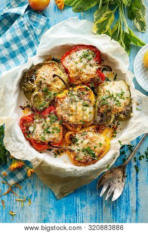 Stuffed Peppers,  Halves Of Peppers Stuffed With Bulgur, Dried Tomatoes, Herbs And Cheese In A Bakin