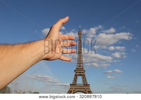 Hadn Of Man Catching The Eiffel Tower In Paris France