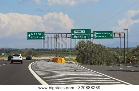 Italian Road Signs On Motorway Near Rome City And The Arrows Directions To Naples And More Cars