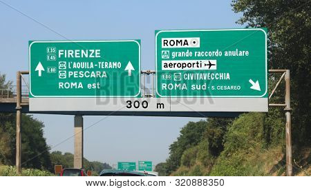 Road Junction On Italian Highway With Directions To Rome Or Florence In Italy