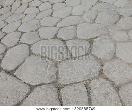 Background Of Old Stones Of An Ancient Roman Road In Italy
