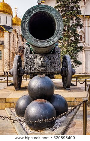 Huge Old Tarnished Ornate Canon, Tsar Pushka, On Wheels With Stack Of Cannonballs In Front, Located 