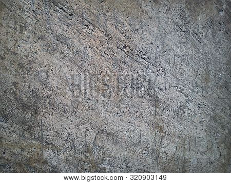 Roughly Machined Metal Surface With Diagonal Lines, Gray And Black Blotches, Inscriptions And Letter