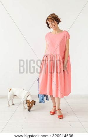 Pets Owner Concept - Young Woman In Pink Dress With Jack Russell Terrier Dog Over The White Backgrou