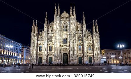 Milan Cathedral Or Duomo Di Milano At Night, Italy. It Is A Top Landmark Of City. Ornate Gothic Faca