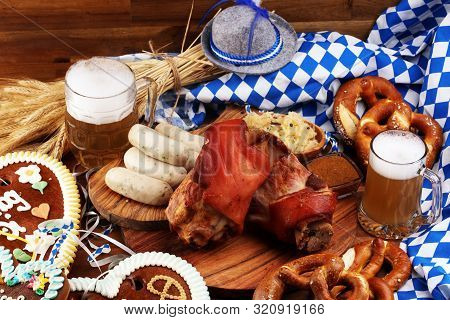 Traditional German Cuisine, Schweinshaxe Roasted Ham Hock. Beer, Pretzels And Various Bavarian Speci