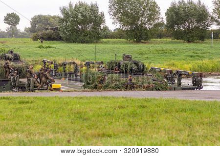 Minden / Germany - September 4, 2019: Panzerpionierbattaillon Trained A Tank Crossing Over A River W