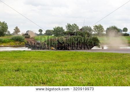 Minden / Germany - September 4, 2019: Panzerpionierbattaillon Trained A Tank Crossing Over A River W