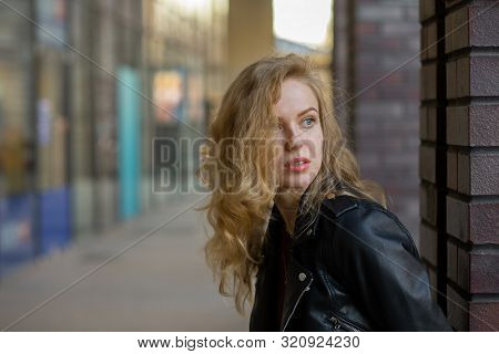 Blond Girl With Pimply Skin On City Street Looking Aside