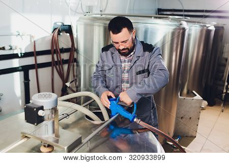 Portrait Of Brewer Who Is Making Beer On His Workplace In The Brew-house..