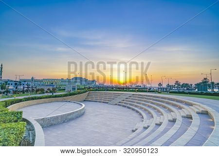 Outdoor Event Seating In Park Under Sunset Glow Near The Corniche In Old City Of Doha At Dusk, Qatar