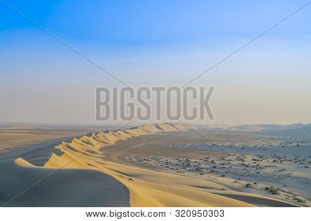 Desert At Sunrise, Sealine Desert Formations With Low Sun Highlighting Leading Face Of Dunes And Rip