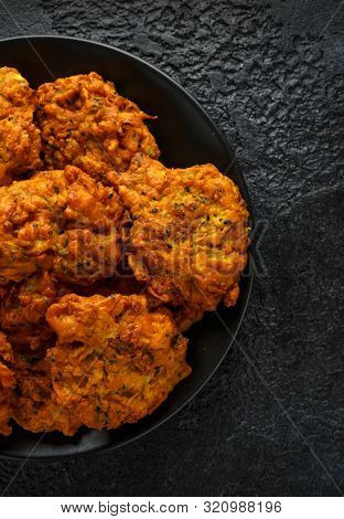 Indian Takeaway Food, Spicy Onion Bhajis On Black Plate