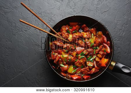 Chicken Manchurian In Pan At Black Concrete Background. Chicken Manchurian Is Indian Chinese Cuisine